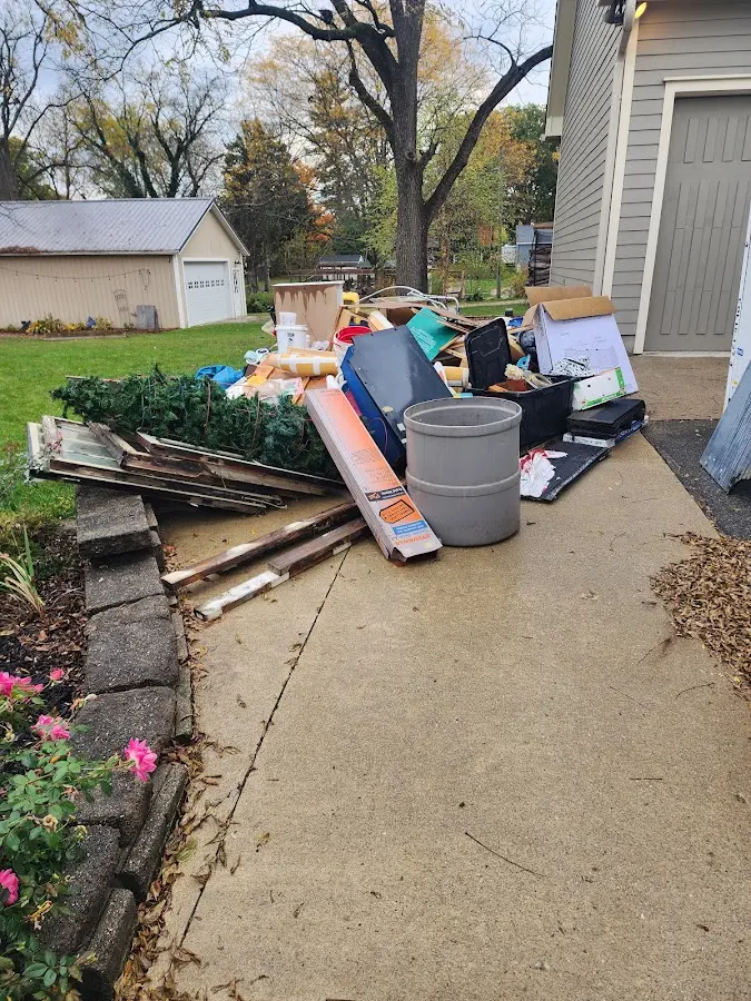 Dumpster being loaded with debris for Estate Cleanout Dumpster Rental in Delhi Hills